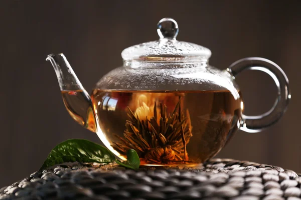 Teapot on a wicker mat on dark background — Stock Photo, Image