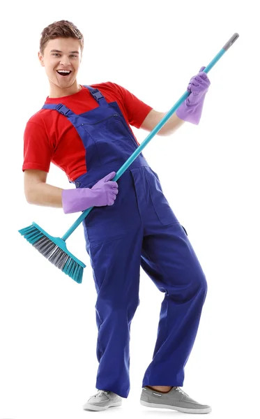 Jovem zelador com escova de chão — Fotografia de Stock