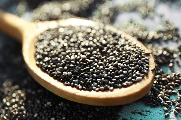 Spoon of chia seeds on wooden background — Stock Photo, Image