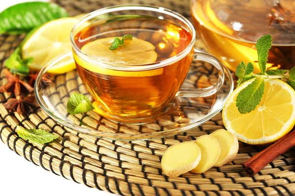 Cup of tea with ginger on a wicker mat, closeup — Stock Photo, Image