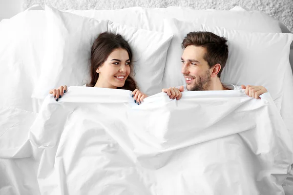 Casal deitado juntos na cama . — Fotografia de Stock