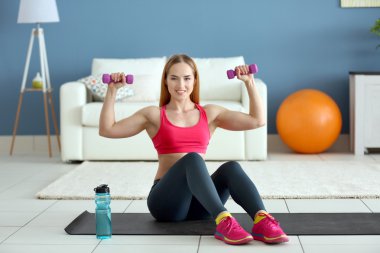 sportswoman doing exercises with dumbbells clipart