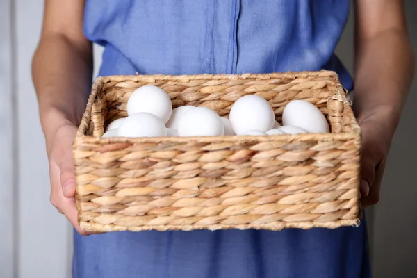 Huevos en cesta en manos de mujer —  Fotos de Stock