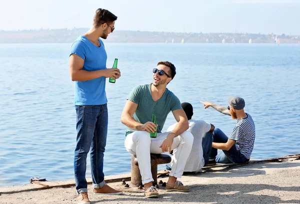 Men talking on the riverside — Stock Photo, Image