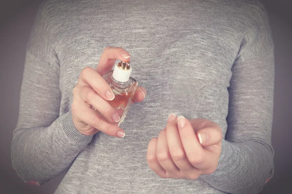 woman applying perfume