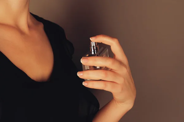 woman applying perfume