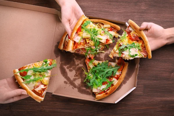 People hands with sliced pizza — Stock Photo, Image