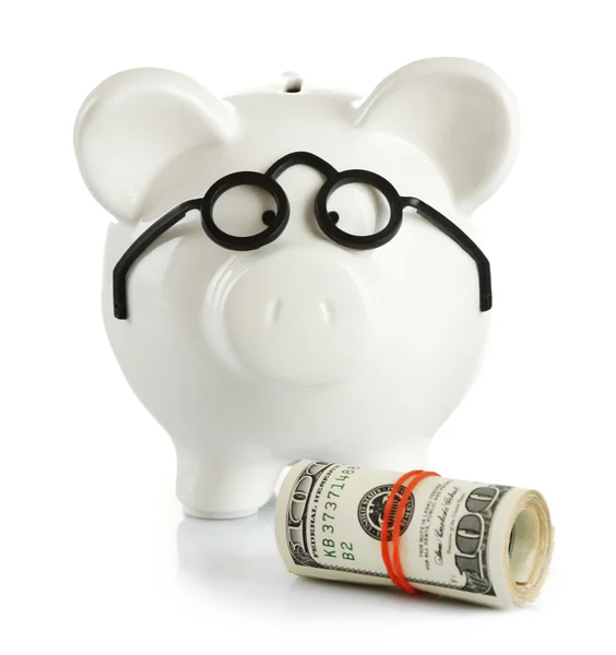 Sparschwein in Brille mit Dollarrollen — Stockfoto
