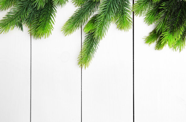 Fir twigs on wooden background