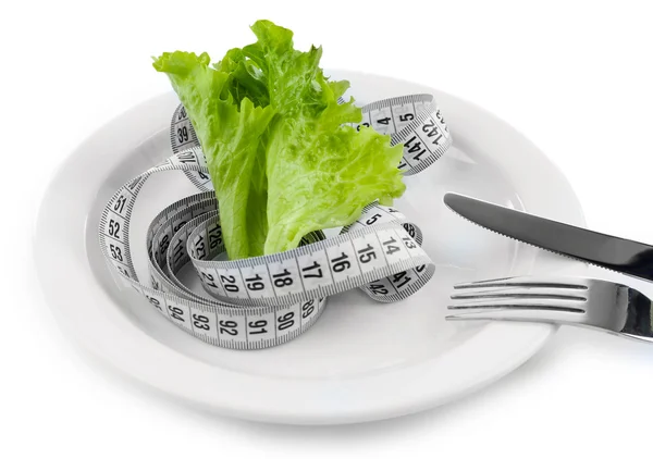 Green lettuce leaf with measuring tape — Stock Photo, Image