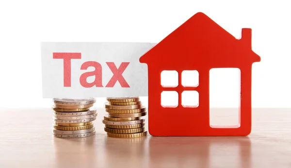 House figure, coins and tax sign — Stock Photo, Image