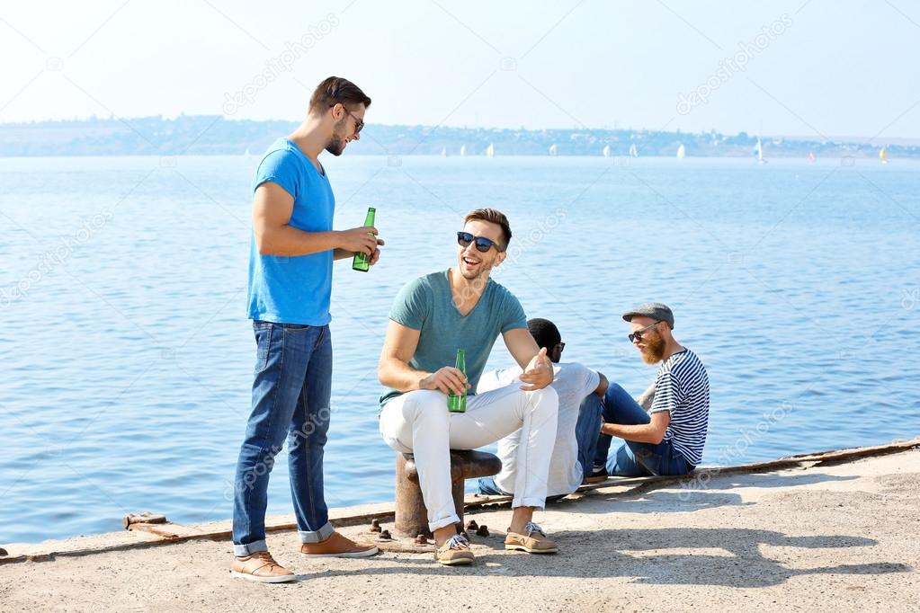 men talking on the riverside