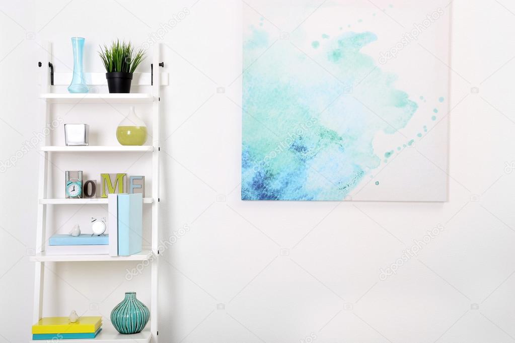 White bookcase with picture in room