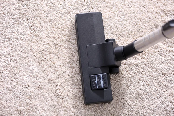 Vacuum cleaner sweeping carpet — Stock Photo, Image