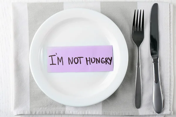 Text I'M NOT HUNGRY in plate — Stock Photo, Image