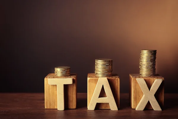 Word tax with stacked coins — Stock Photo, Image