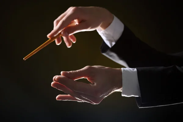 Music conductor directing with baton — Stock Photo, Image