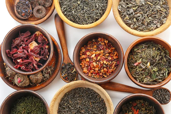 Variety of dry tea in pots — Stock Photo, Image