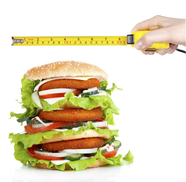 Huge burger and hand with roulette — Stock Photo, Image