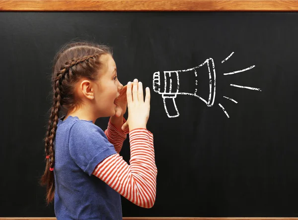 Cute girl posing at blackboard — Stock Photo, Image