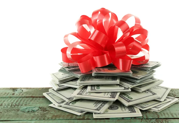 Pile of dollars with bow as gift — Stock Photo, Image