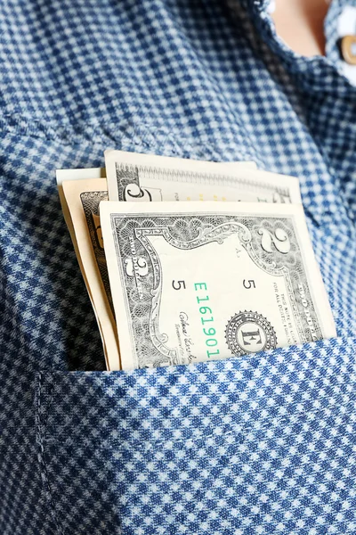 Money in cotton shirt pocket