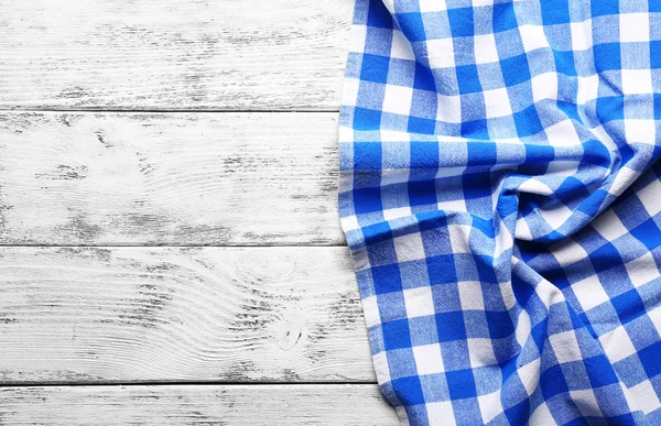 Checkered napkin on wooden — Stock Photo, Image