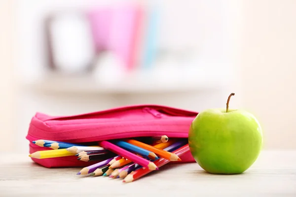 Apple och penna-box på bord — Stockfoto