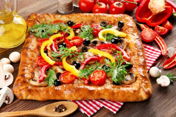 Freshly homemade pizza on wooden table closeup — Stock Photo, Image