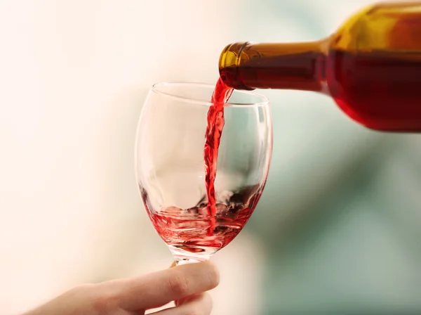 Pouring red wine into glass at hen-party, close up — Stock Photo, Image