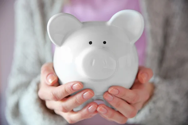 Woman holding in hands piggy bank — Stock Photo, Image