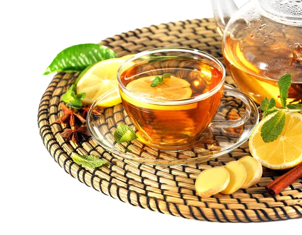 Cup of tea with ginger on a wicker mat isolated on white — Stock Photo, Image