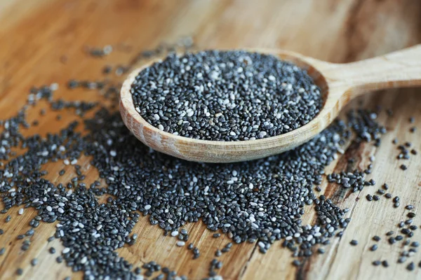 Spoon of chia seeds on wooden background — Stock Photo, Image