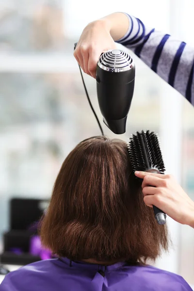 hairdresser drying hair