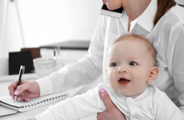 Baby boy on businesswoman's hands — Stock Photo, Image