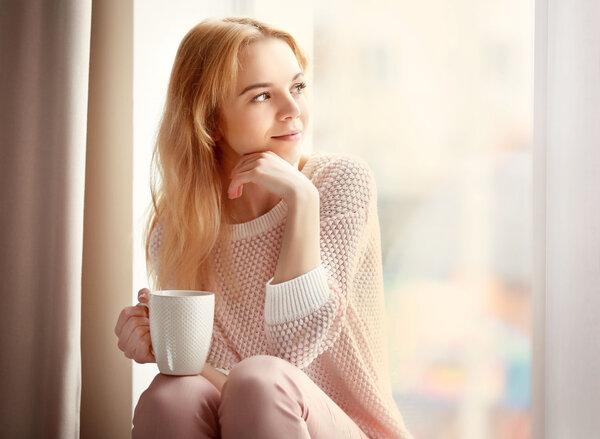 Blonde beautiful girl with cup of tea