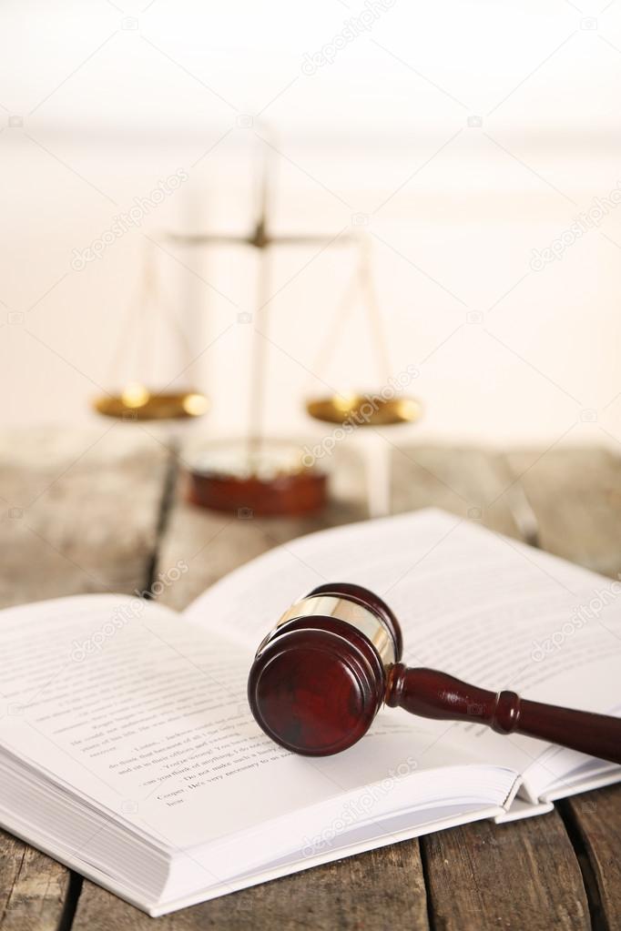 Wooden gavel with open book and scales