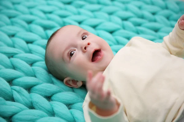 Lovely baby on knitted background — Stock Photo, Image