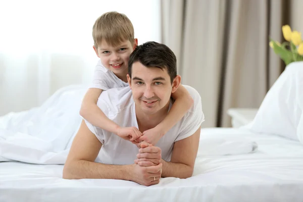 Portrait Son Father Lying Bed Home Stock Image