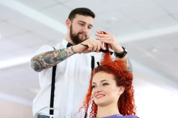 Hairdresser cutting red curls — Stock Photo, Image