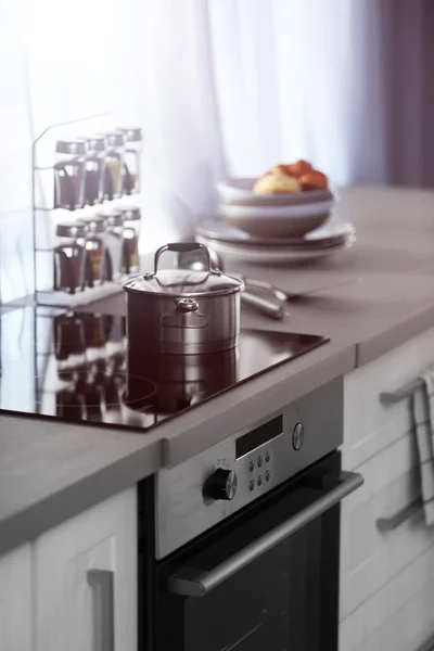 Modern kitchen table with electric stove — Stock Photo, Image