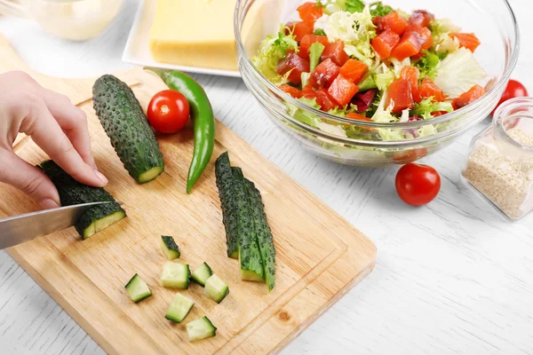 Kvinnliga händer skär grönsaker — Stockfoto
