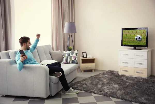 Hombre joven viendo la televisión en casa —  Fotos de Stock