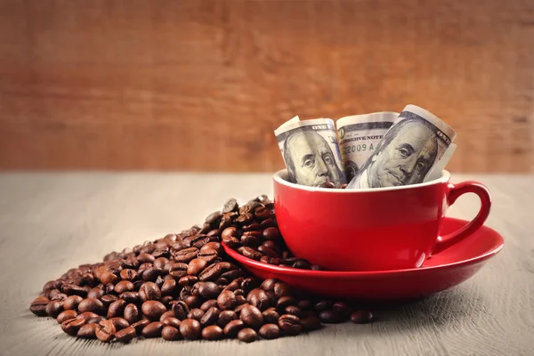 Coffee beans, cup and US dollar banknotes Stock Picture