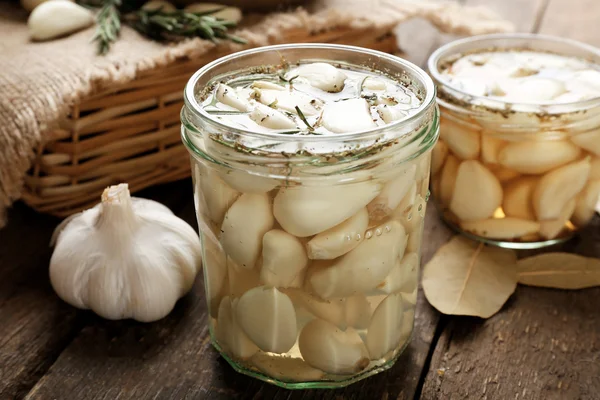 Garlic with spices on wooden table — Stock Photo, Image