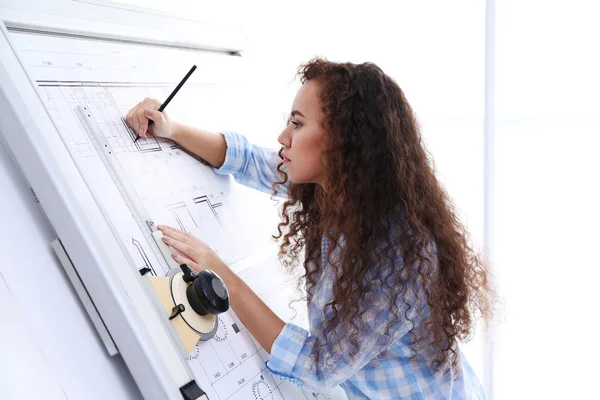 Female architects working on blueprints — Stock Photo, Image