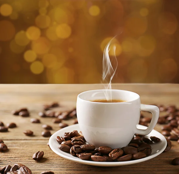 Cup of coffee on table on brown background — Stock Photo, Image