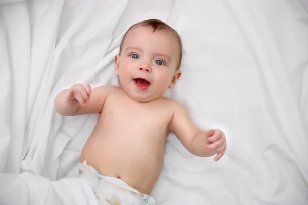 Adorable baby on soft bed — Stock Photo, Image