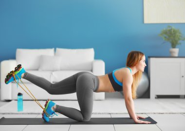 sportswoman doing exercises with rubber band clipart