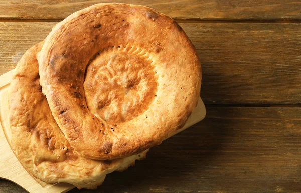 Flat bread on a wooden cutting board — Stock Photo, Image